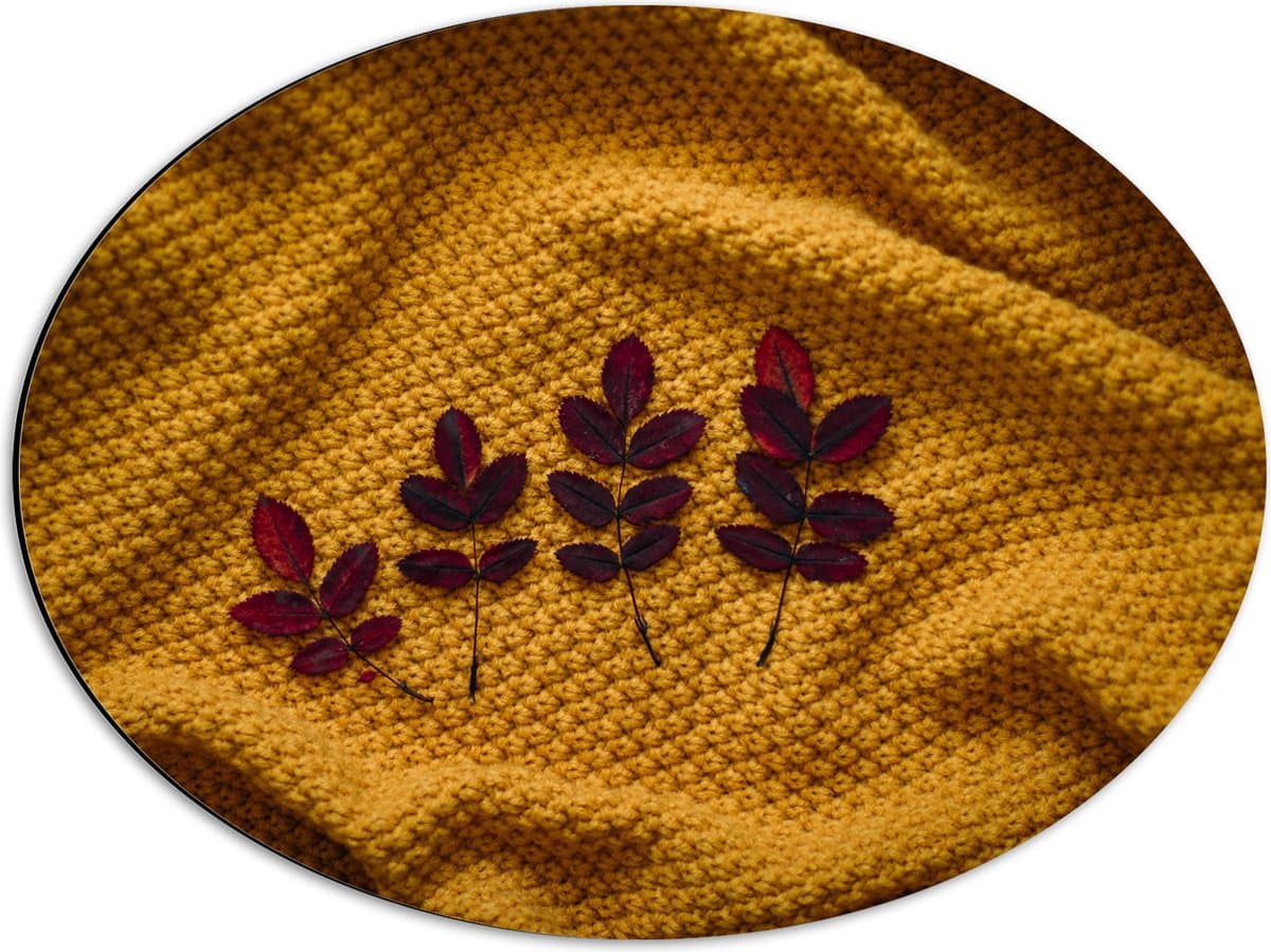Dibond Ovaal - Kleine Rode Blaadjes van Plant op Okergeel Deken - 56x42 cm Foto op Ovaal (Met Ophangsysteem)